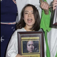 Pictured: Mitski holding a picture of herself